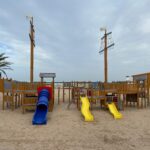 Vibrant pirate ship playground on Playa de Gandía beach, Spain.